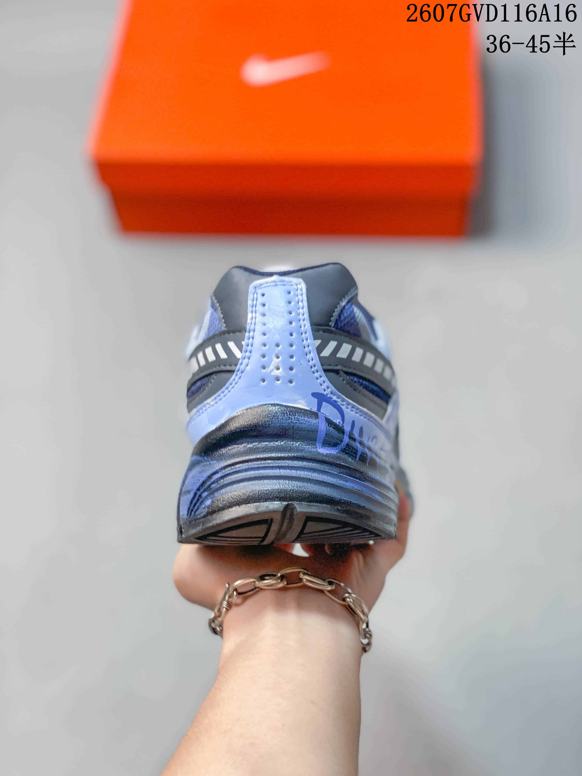 Rear view showing the layered heel structure and blue-gray upper details.
