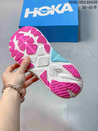 Close-up of the pink, white and aqua outsole on a blue running shoe