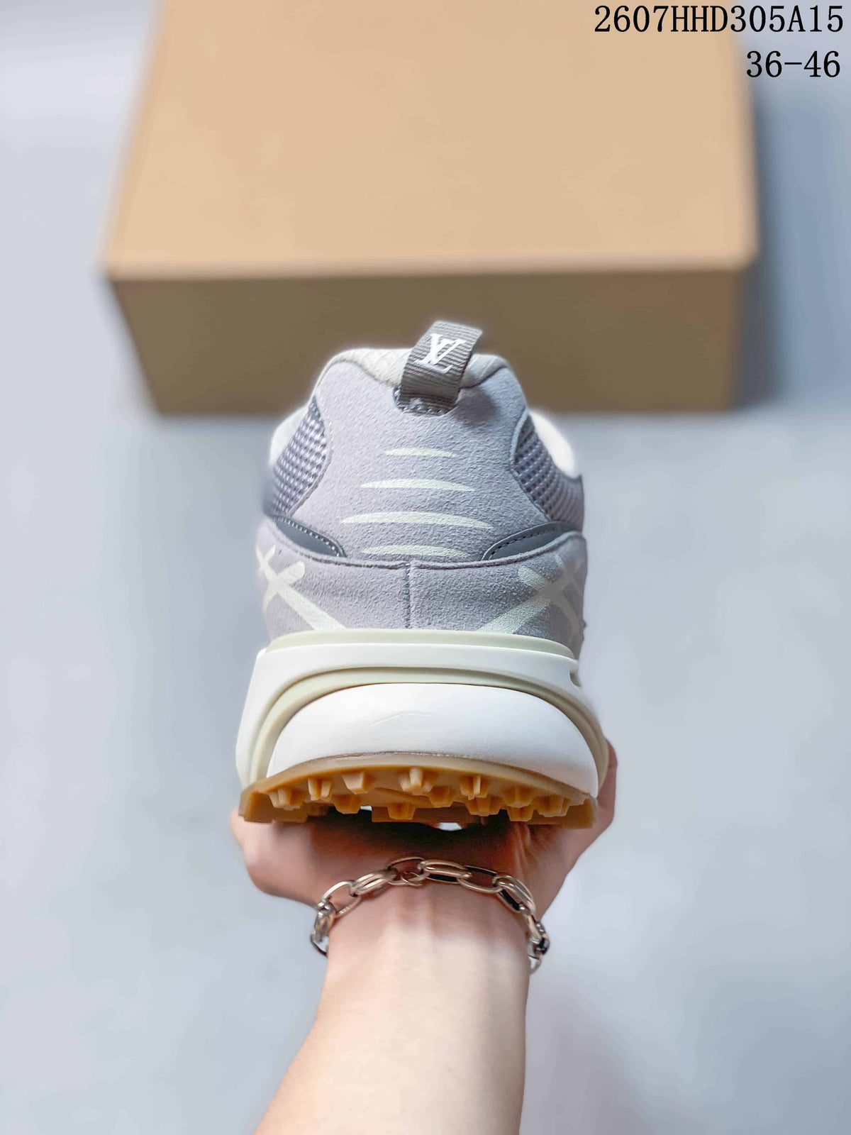 Rear view of the gray sneaker showing the padded heel, pull tab, layered heel structure, and tan outsole.