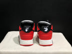 Rear view of the sneaker pair showing red heel panels, black collars, and white heel branding details.