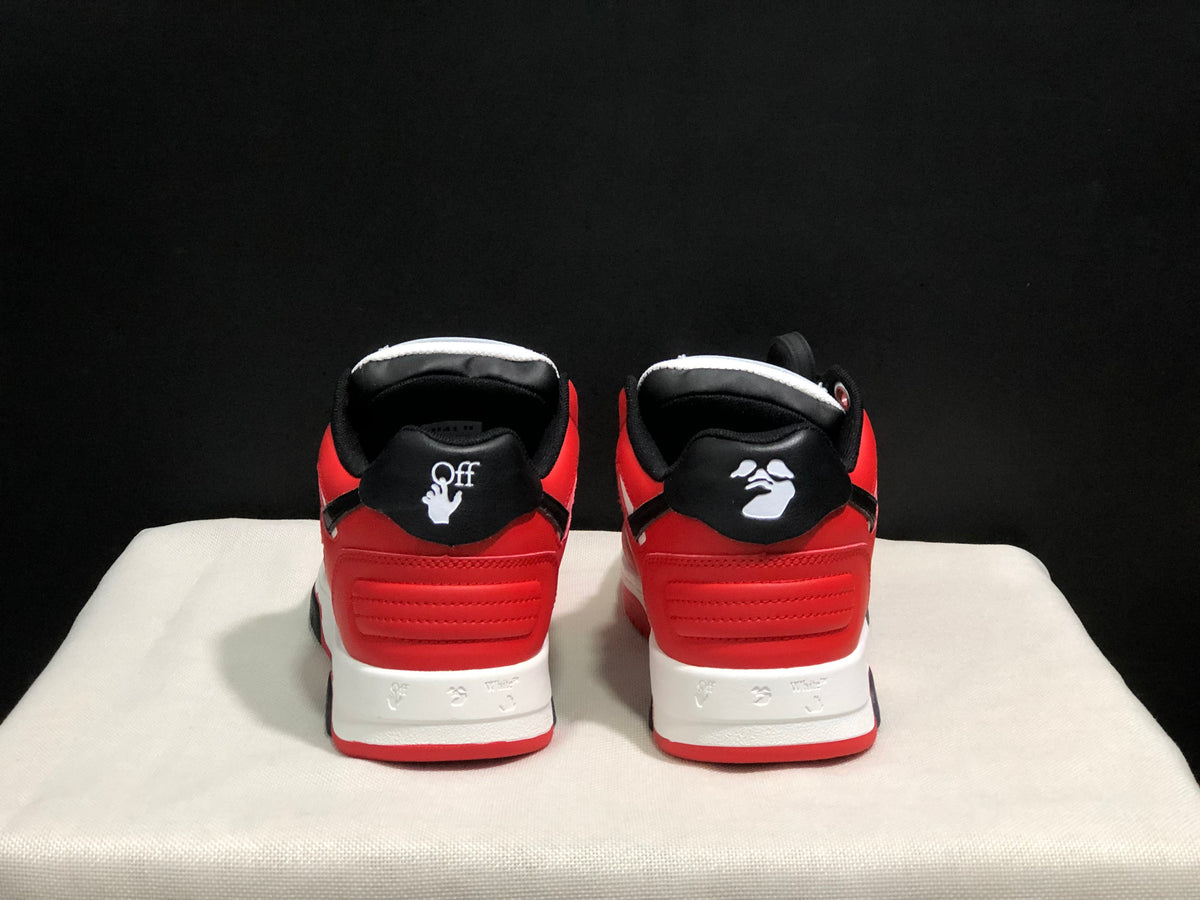 Rear view of the sneaker pair showing red heel panels, black collars, and white heel branding details.