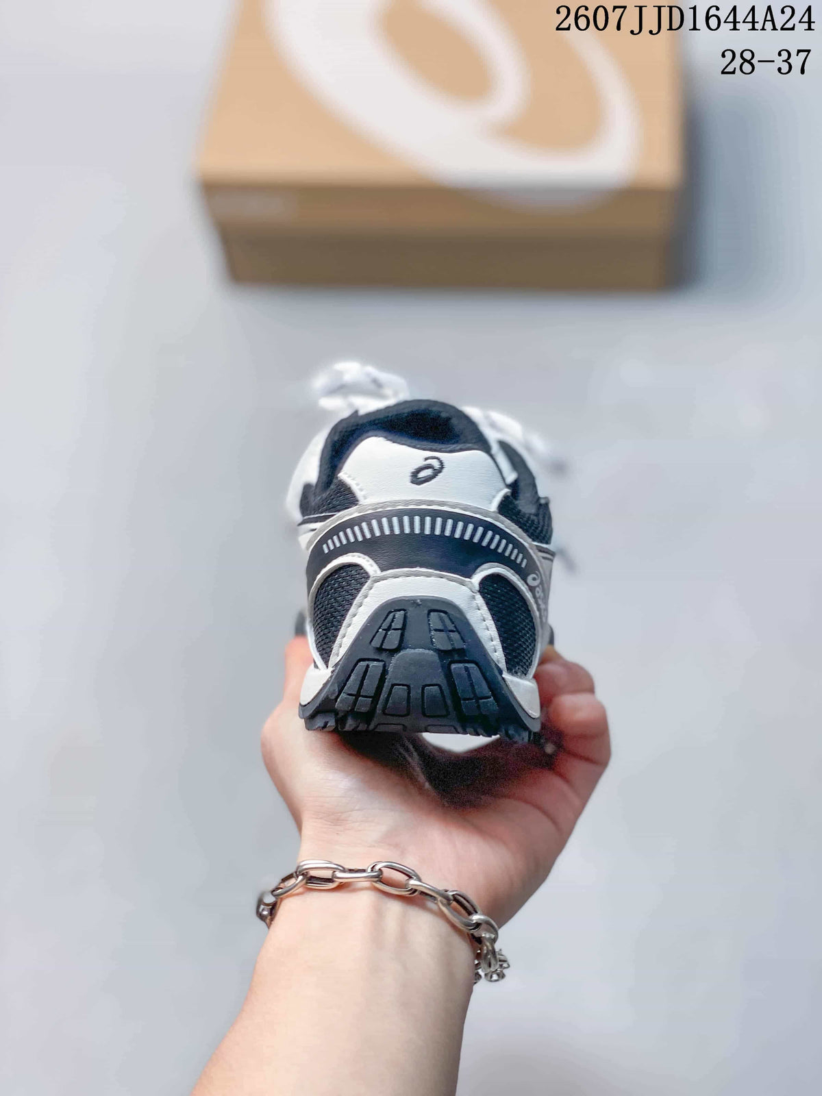 Rear view of an ASICS HYPERSYNC kids’ sneaker showing the layered heel construction and dark outsole.