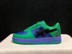 Side profile showing the glossy green and blue upper, black star-shaped side detail, purple midsole and green outsole.
