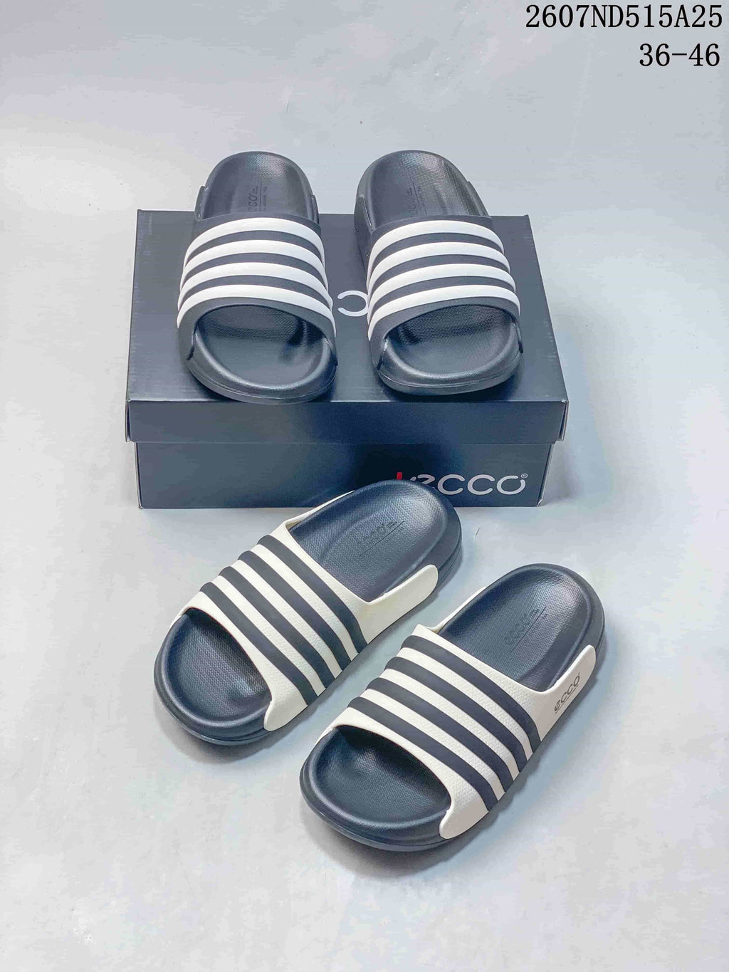 Navy and white ECCO slide sandals arranged in front of and on a branded box, with style code 2607ND515A25 and size range 36–46 visible.