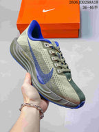 Side view of a gray and blue Nike Pegasus Plus Next Nature running shoe