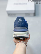 Rear view of the navy trainer showing the padded blue collar, heel branding and layered sole.