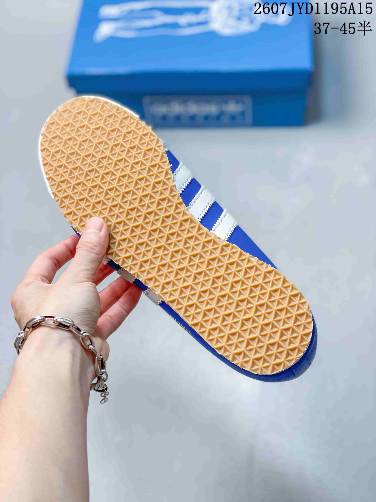 Close view of the sneaker outsole showing a dense repeating triangular tread pattern.