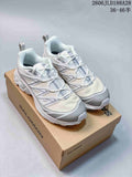 Pair of white and grey Salomon XT-6 Expanse shoes on a box