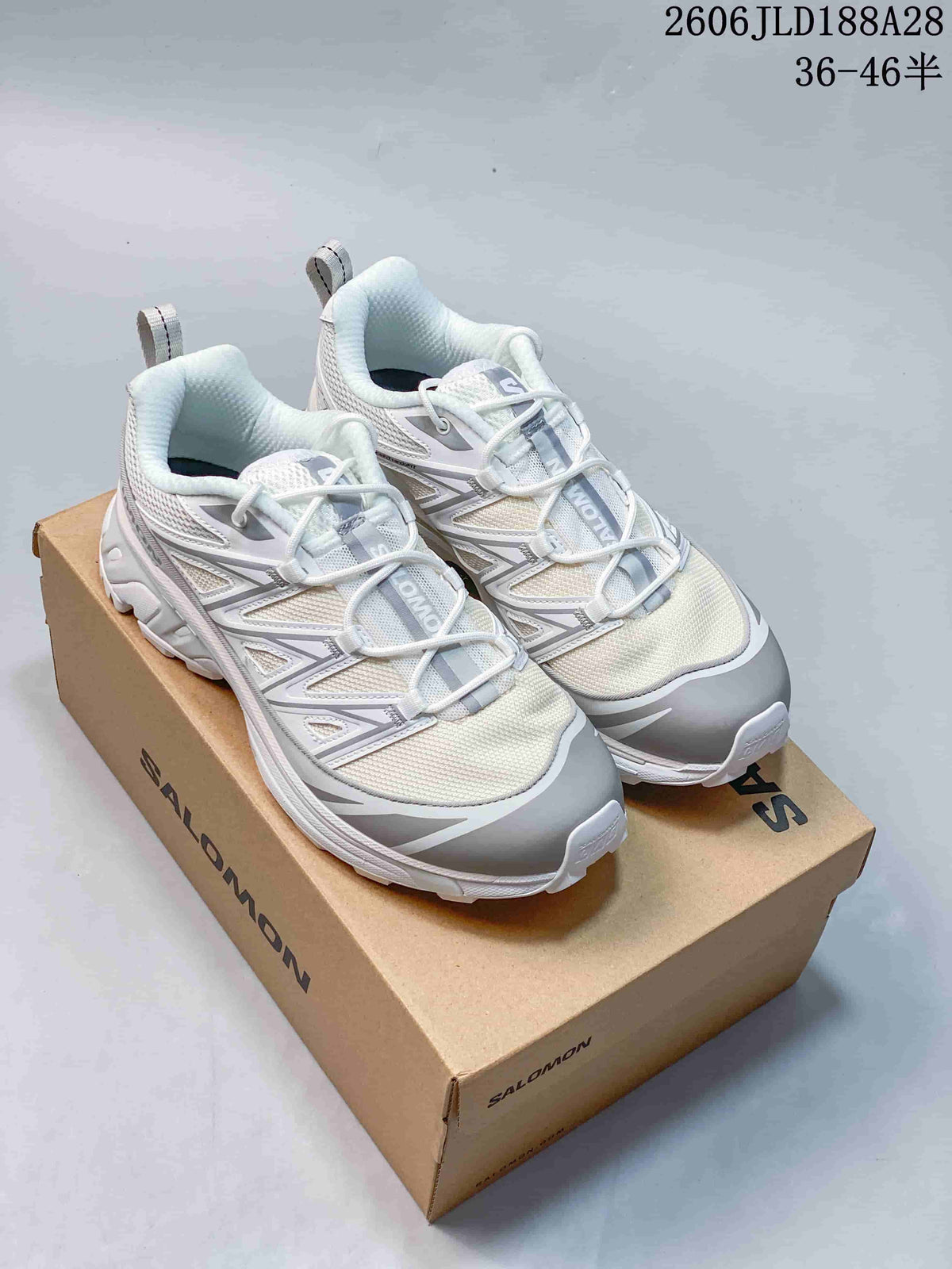 Pair of white and grey Salomon XT-6 Expanse shoes on a box