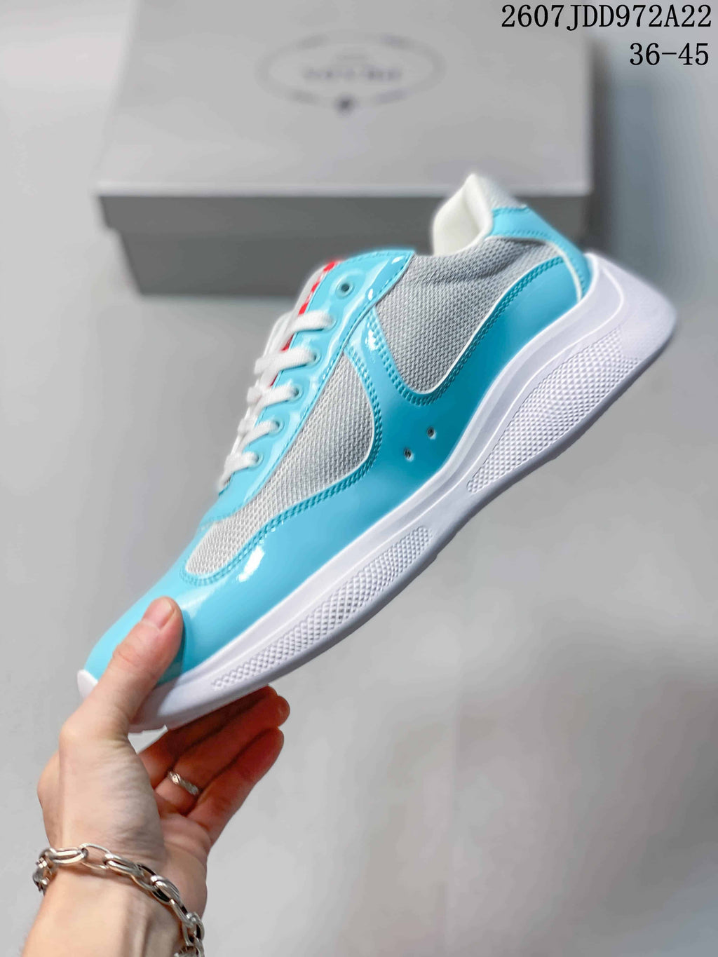 Side view highlighting the turquoise overlay panels, textured contrasting sections, and white sole.
