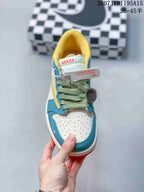 Top view showing the perforated white toe box, blue overlays, patterned laces, and attached decorative accessories.