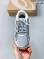 Top view of the silver sneaker showing the mesh-like toe box, tongue, and lace arrangement.