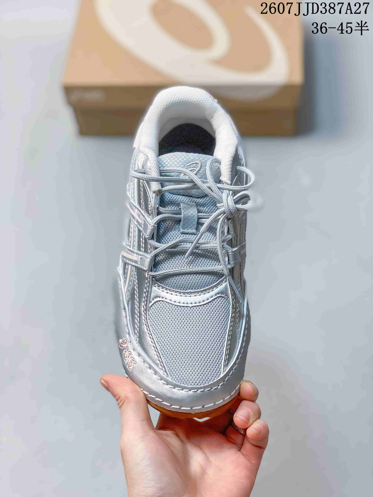 Top view of the silver sneaker showing the mesh-like toe box, tongue, and lace arrangement.