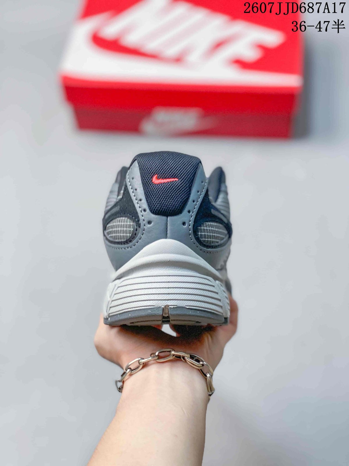 Rear view of a gray Nike V5 RNR sneaker showing the padded collar, heel panels, and white-gray midsole.