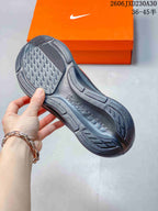 Close view of the patterned outsole on a dark gray running shoe.