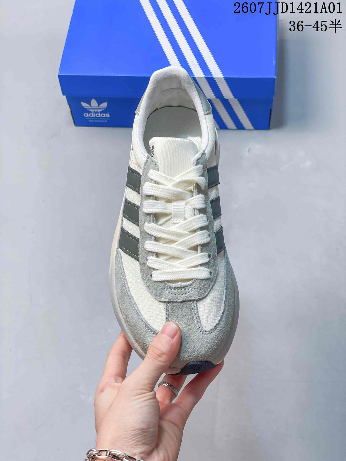 Top view of the lace-up Adidas sneaker with dark grey side stripes
