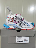 Multicolor Balenciaga Runner sneaker displayed on its box, showing the white mesh upper, colored overlays and layered sole.