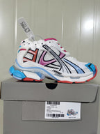 Multicolor Balenciaga Runner sneaker displayed on its box, showing the white mesh upper, colored overlays and layered sole.