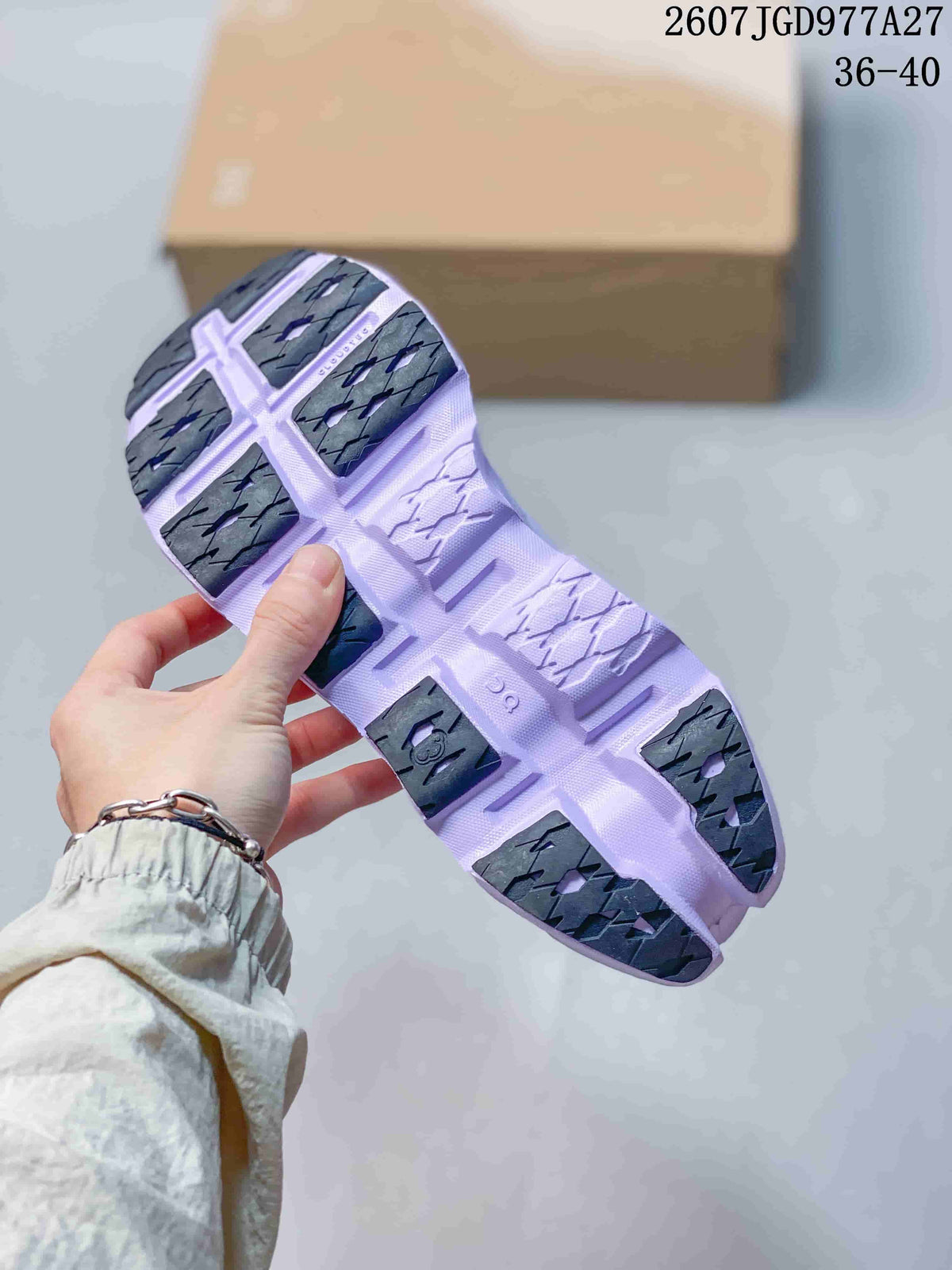 Underside view of the lavender sneaker showing segmented dark rubber outsole sections and the product text 2607JGD977A27 with size range 36–40.