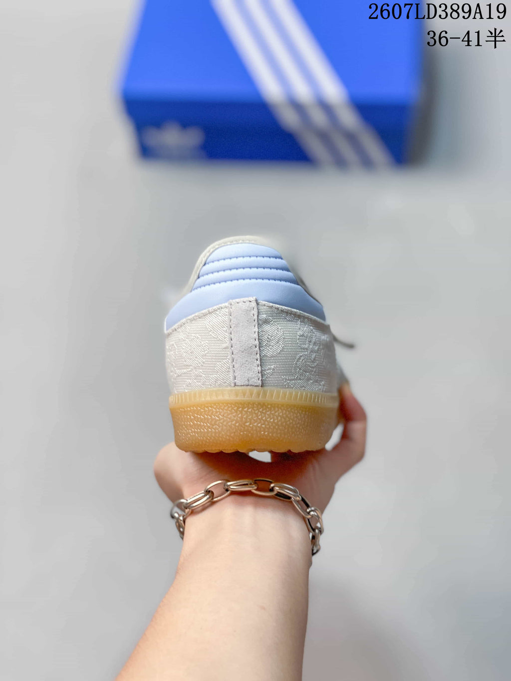 Rear view showing the white heel, silver detailing, and gum-colored outsole.