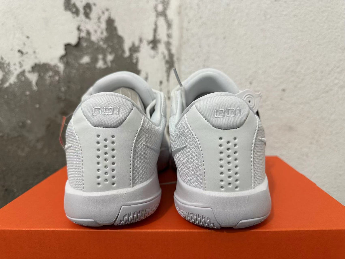 Rear view of white Nike G.T. Cut Academy basketball shoes showing heel details and perforations