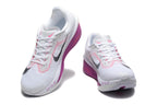 White Nike Zoom Fly 6 shoes with black and pink accents, viewed from the front