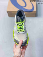Top view of the sneaker showing neon yellow laces, dark tongue padding, and a textured white toe box.