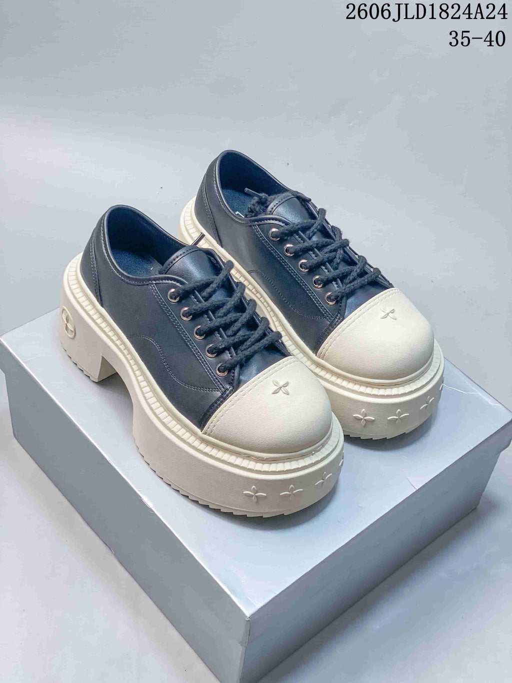 Pair of dark SMFK Future Ripple low-top sneakers with ivory toe caps and chunky platform soles