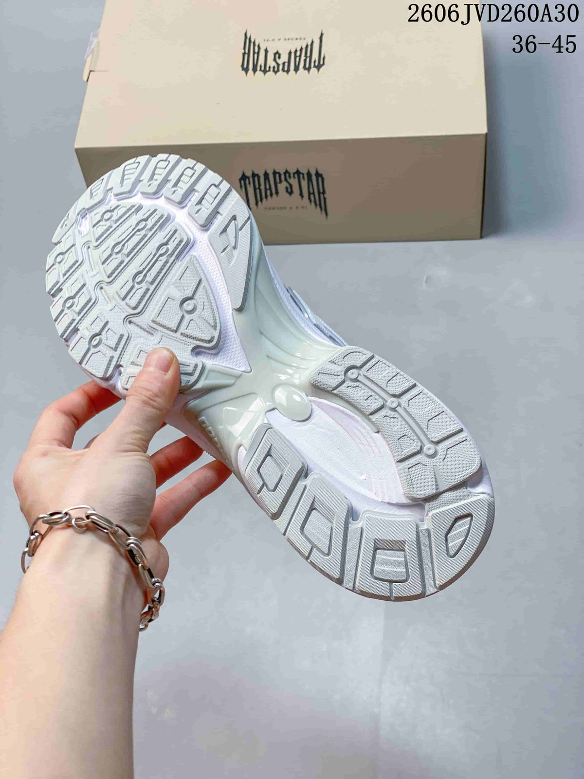 Outsole view of the silver and white chunky Trispeed 3000 Trainer