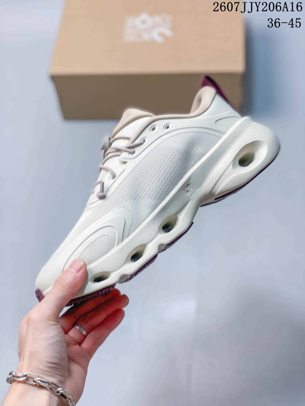 Side view highlighting the layered upper, sculpted sole, and visible sole openings.