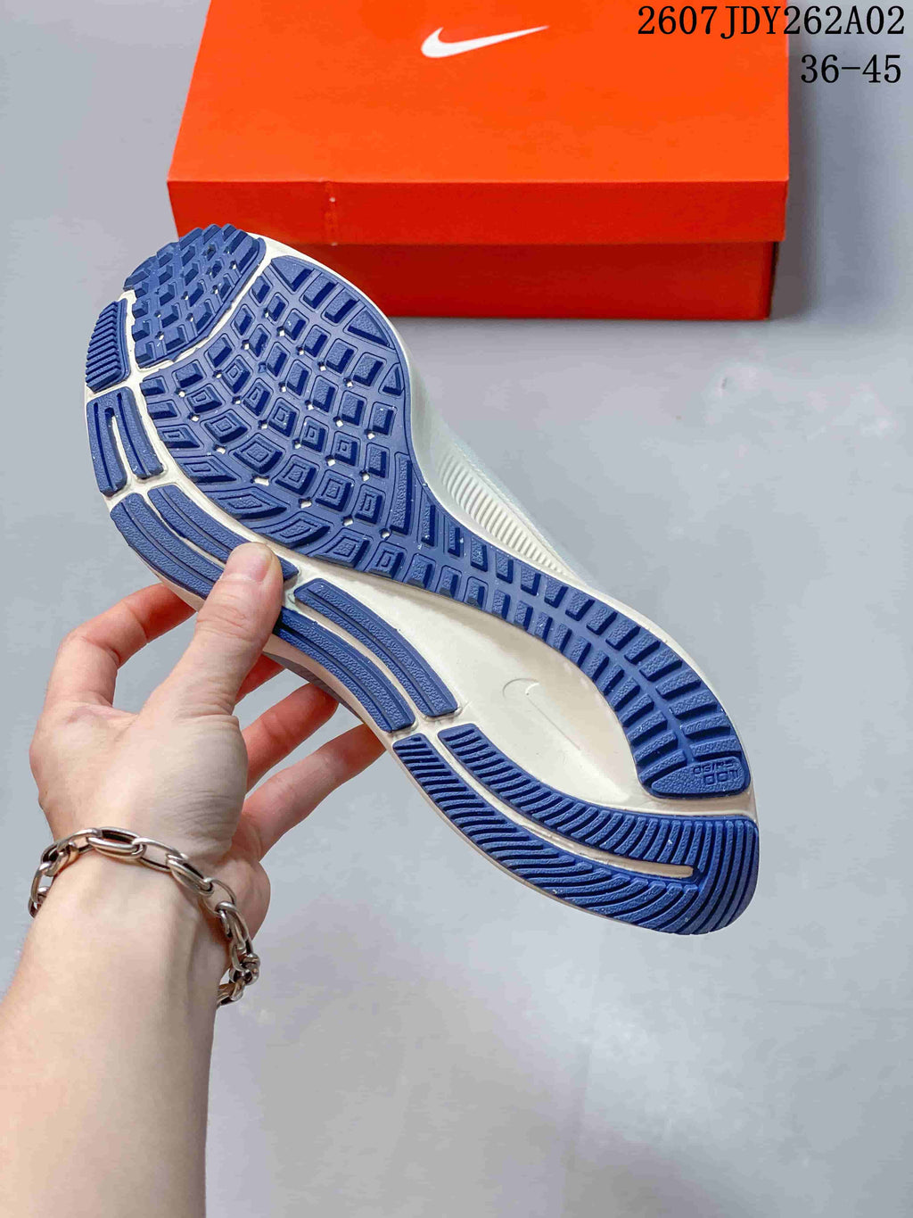 Outsole view of a Nike Pegasus 38 shoe showing its blue tread pattern.