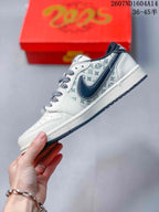 Side profile highlighting the pale patterned side panel, navy Swoosh, white toe area, and dark outsole edge.