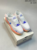 Pair of white Nike SB PS8 sneakers with blue accents and orange outsole edges displayed on a shoebox.