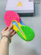 Close view of the colorful basketball shoe outsole showing a geometric traction pattern in pink, green, yellow and blue.