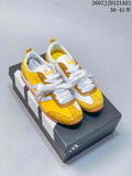 Pair of yellow and white adidas VS JOG 2.0 sneakers with ribbon-style laces, shown on a shoebox.