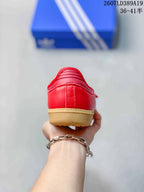 Rear view of the red sneaker showing the stitched heel panel and gum-colored sole edge.