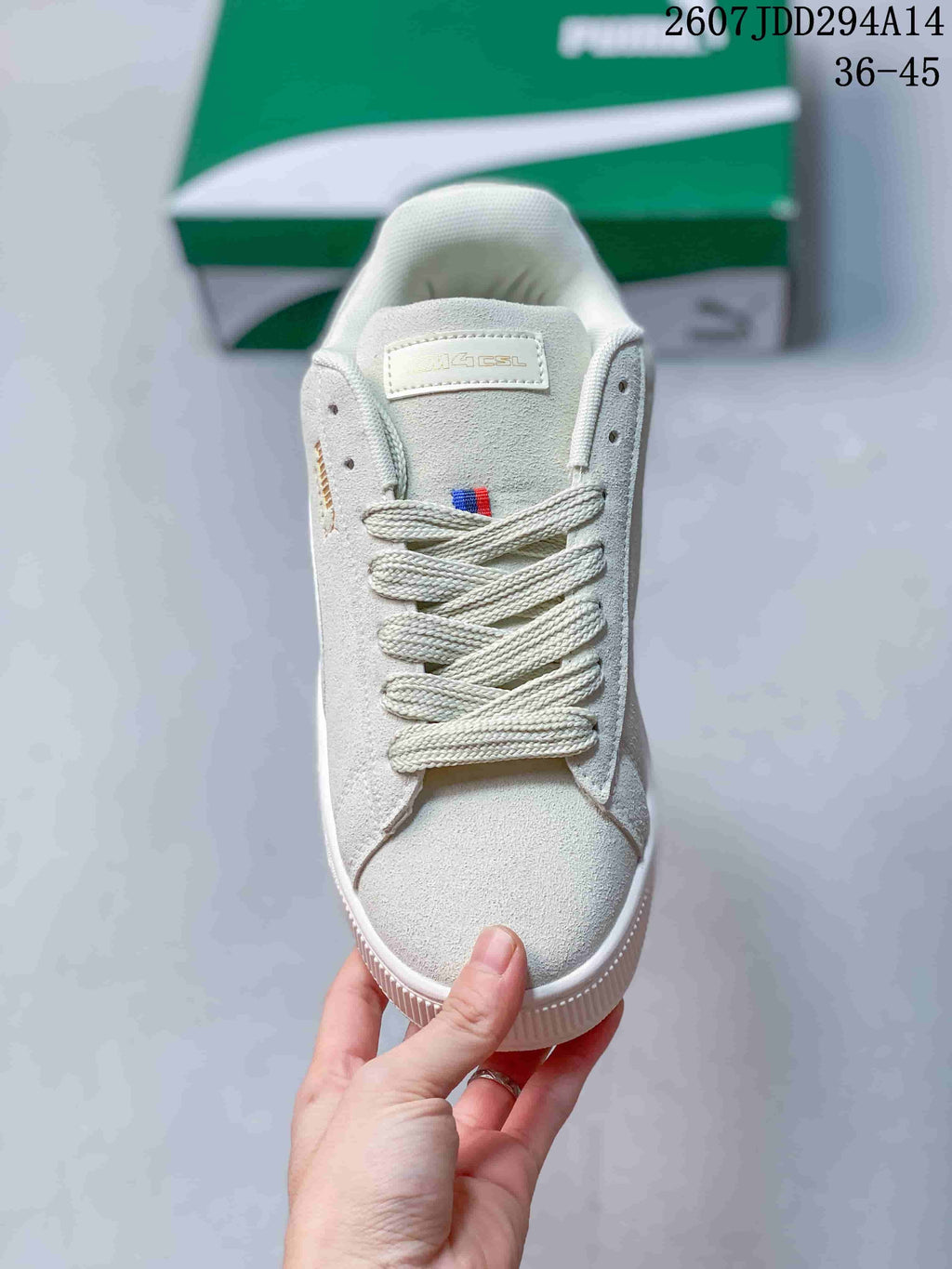 Top view of a white lace-up sneaker showing the padded tongue, woven laces and toe box.