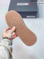 Close view of the gum-colored outsole showing its repeating textured tread pattern; ECCO shoebox and size range 39–44 appear in the background.