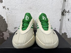 Front view showing green tongues and laces on cream Dame 9 shoes