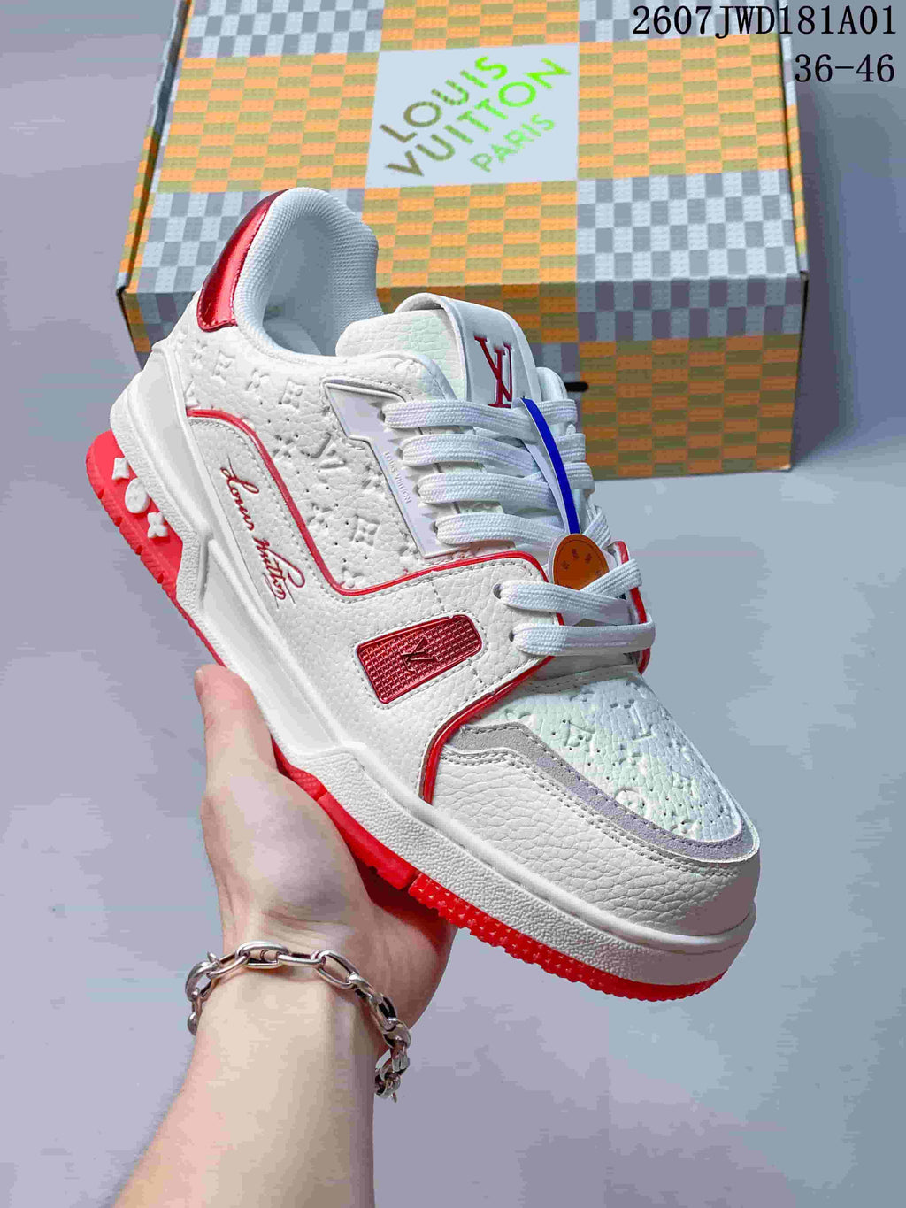 Angled view of the white and red low-top sneaker with textured panels