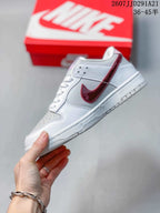 Side profile showing the white upper, red side branding, perforated collar panel, and low-top silhouette.