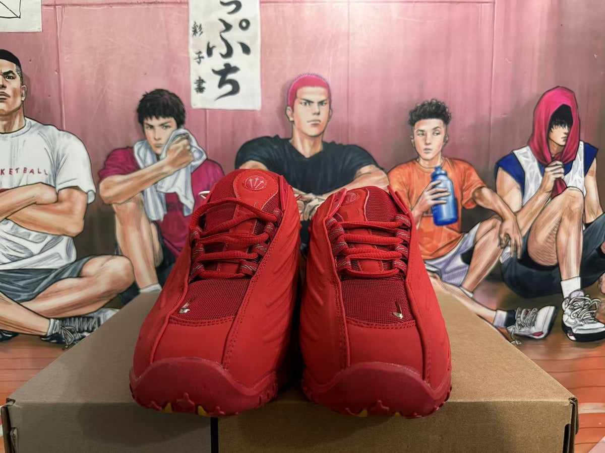 Front view of red lace-up sneakers with mesh details.