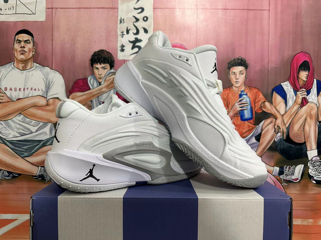 Angled view of a pair of white basketball shoes with grey accents