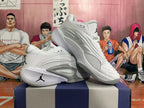 Angled view of a pair of white basketball shoes with grey accents