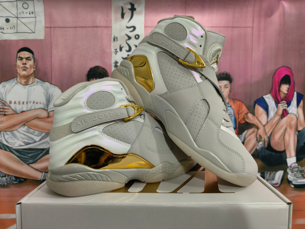 Pair of light gray Jordan high-top sneakers with champagne-gold details