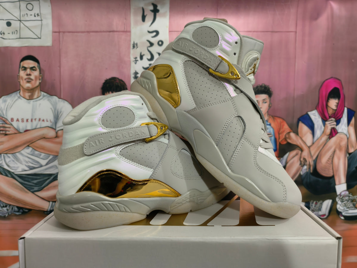 Pair of light gray Jordan high-top sneakers with champagne-gold details