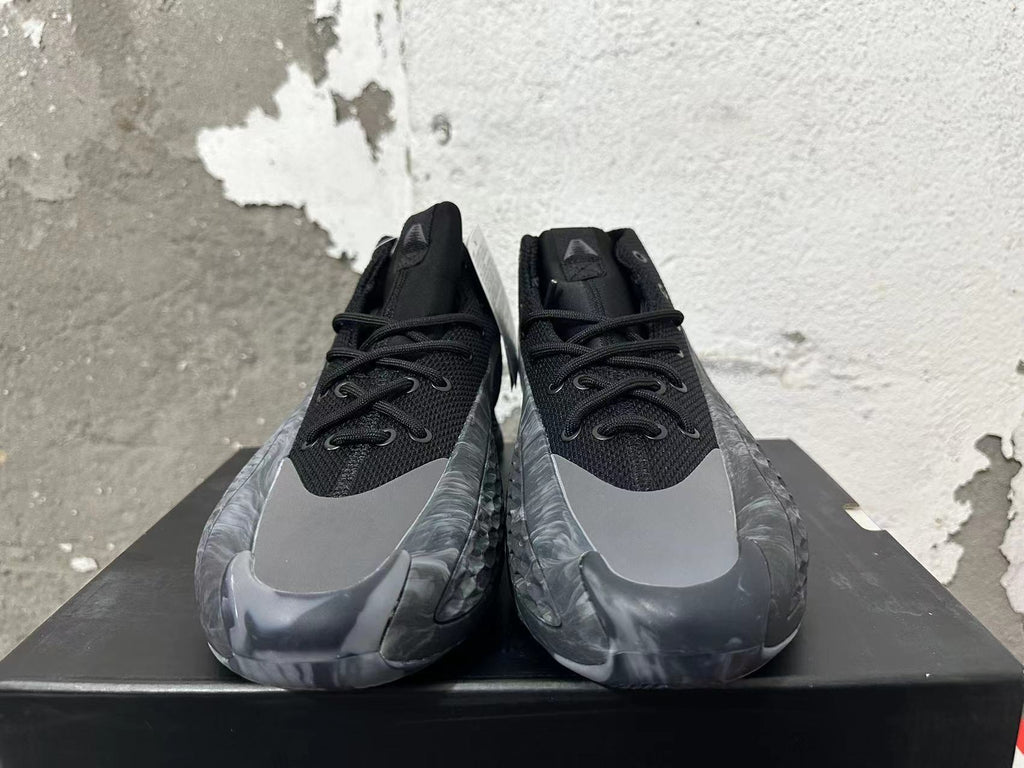Front view of black and grey high-top Adidas basketball shoes with lace-up fronts and grey toe overlays.