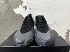 Front view of black and grey high-top Adidas basketball shoes with lace-up fronts and grey toe overlays.