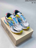 Pair of silver, white, blue, neon yellow, and pink Trapstar Trispeed 3000 sneakers on a box