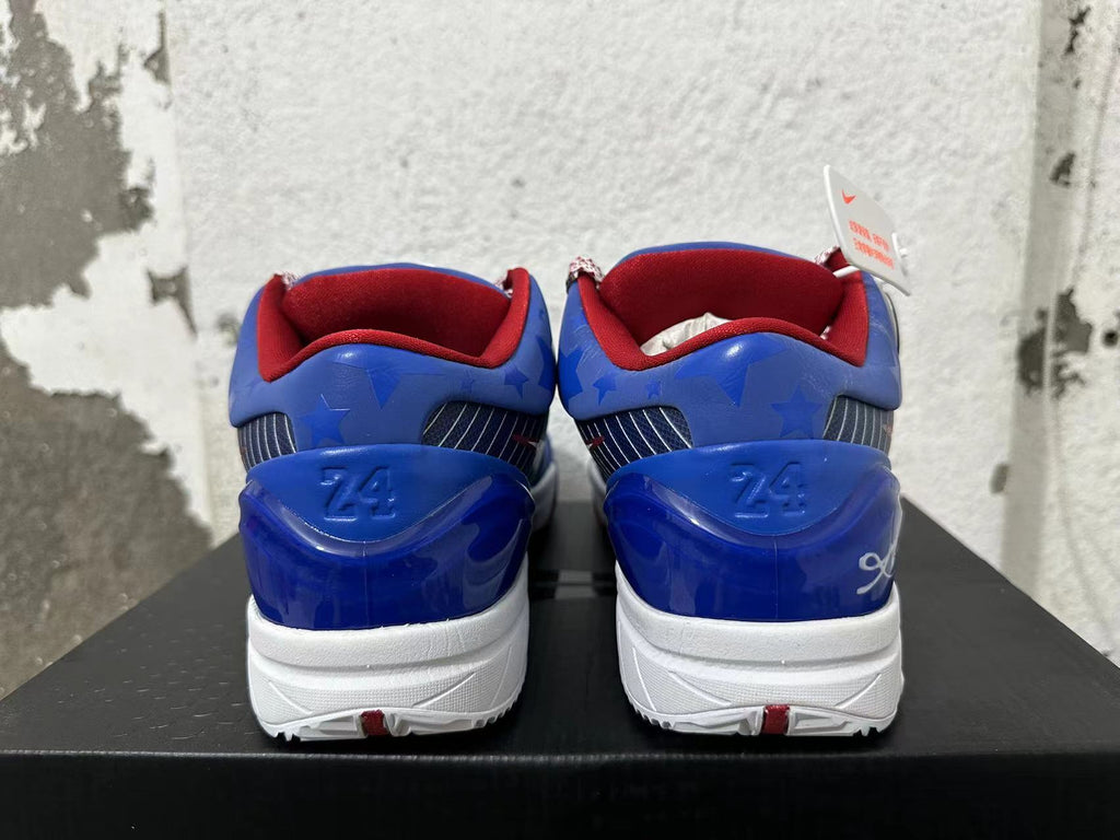 Rear view of blue Nike Kobe basketball shoes with red collars and star-patterned heel details.